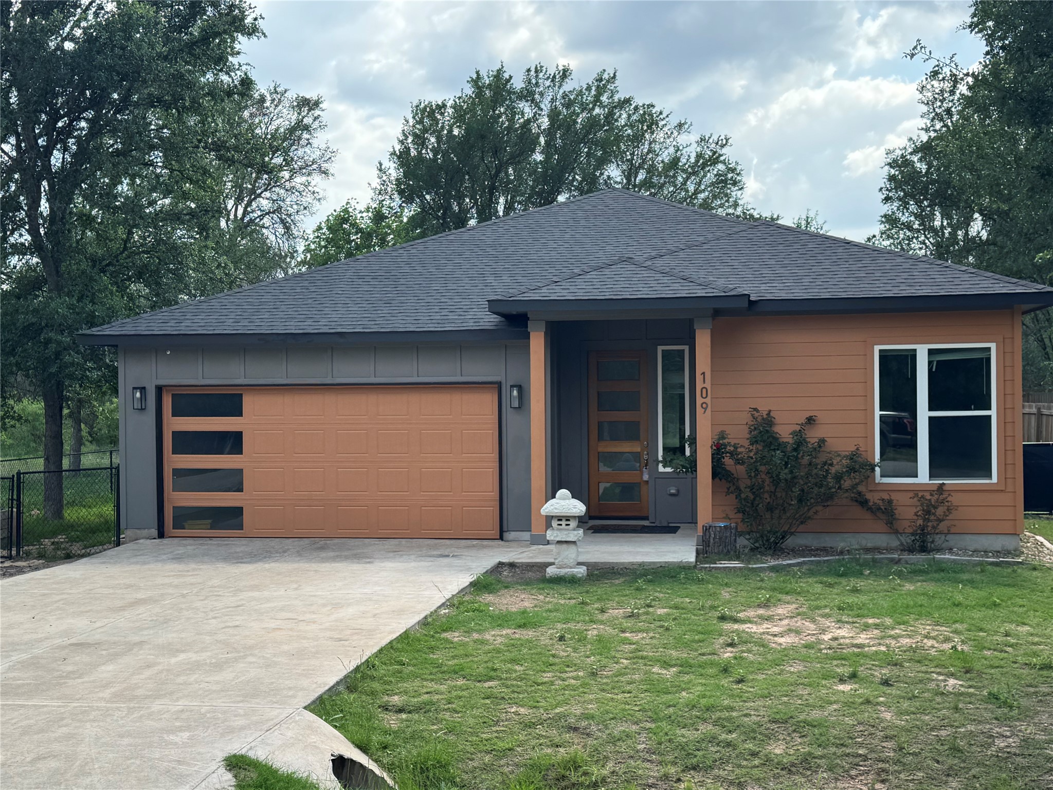 a front view of a house with garden