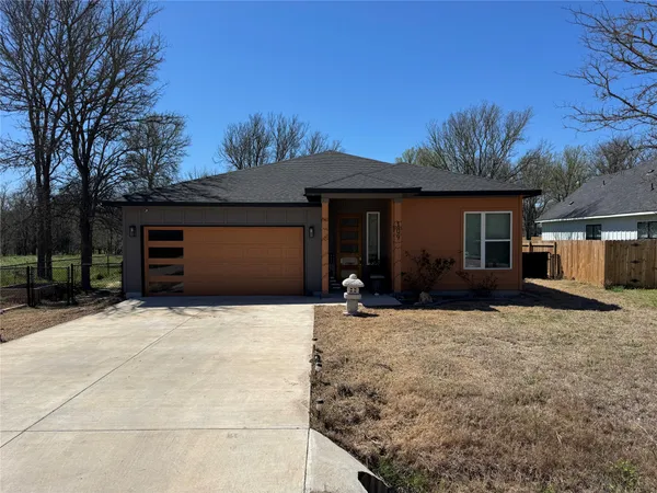 a view of a house with a yard and garage