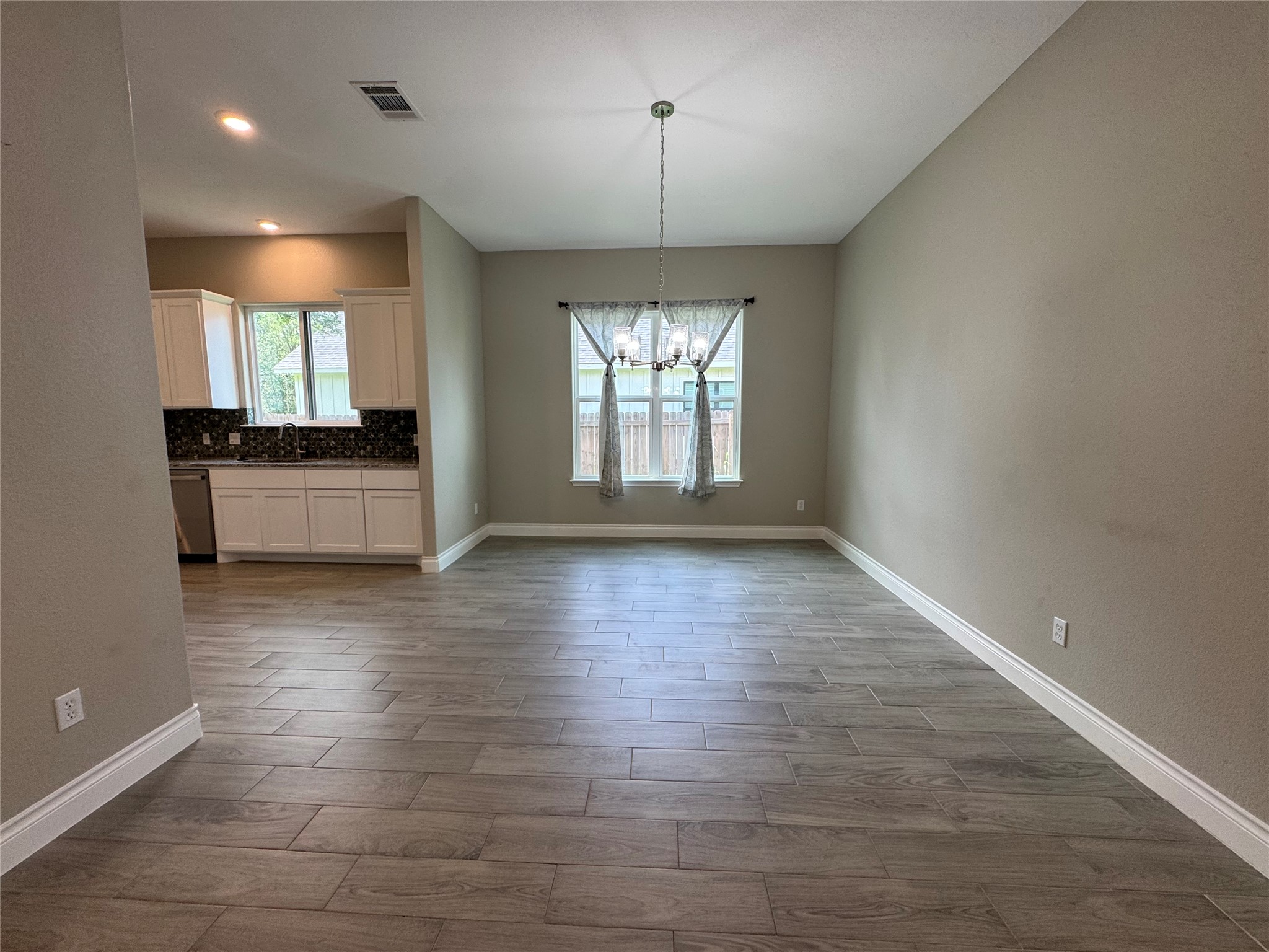 109 Mokulua Bastrop, TX 78602 - Photo 13 of 32 an empty room with wooden floor and windows