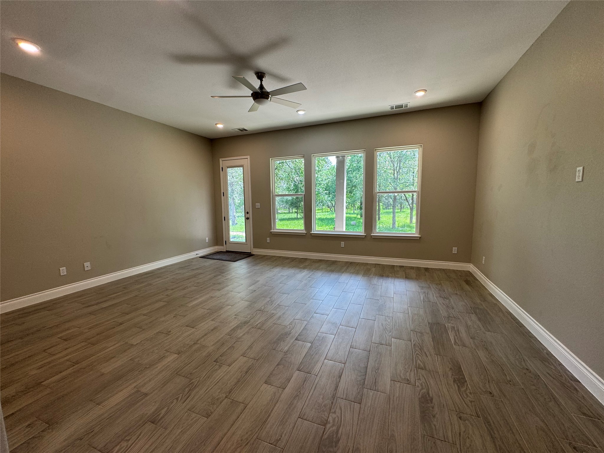 109 Mokulua Bastrop, TX 78602 - Photo 17 of 32 an empty room with wooden floor and windows