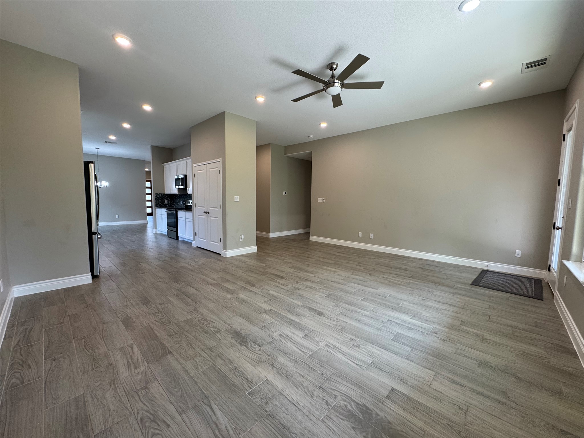 109 Mokulua Bastrop, TX 78602 - Photo 18 of 32 an empty room with wooden floor and windows