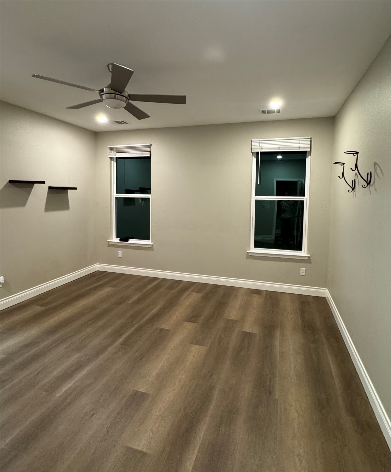 109 Mokulua Bastrop, TX 78602 - Photo 20 of 32 a view of an empty room with a window and wooden floor