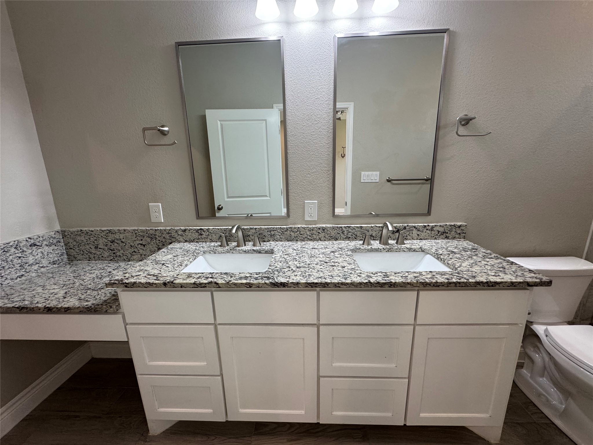 109 Mokulua Bastrop, TX 78602 - Photo 22 of 32 a bathroom with a granite countertop sink and a mirror