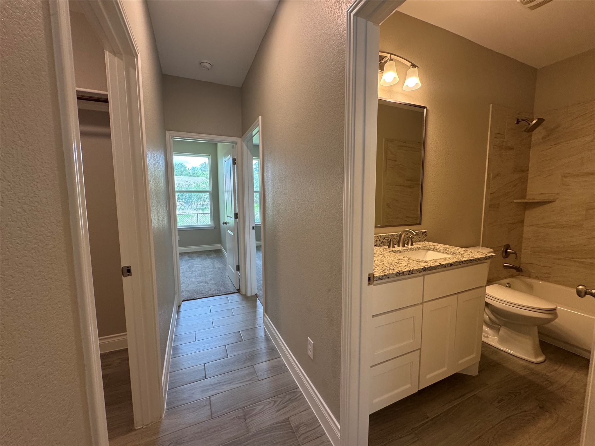 109 Mokulua Bastrop, TX 78602 - Photo 27 of 32 a bathroom with a granite countertop sink toilet and shower