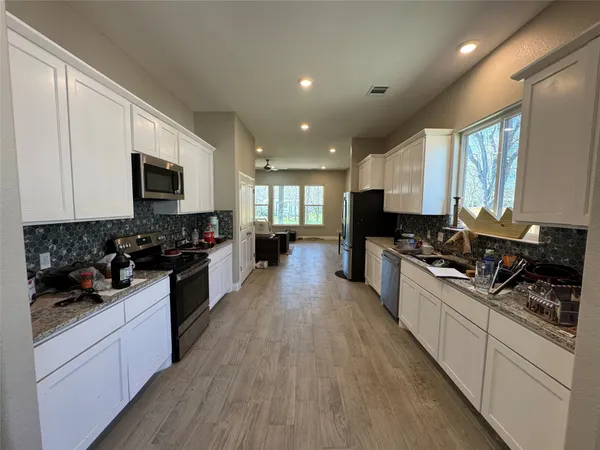 a large kitchen with stainless steel appliances