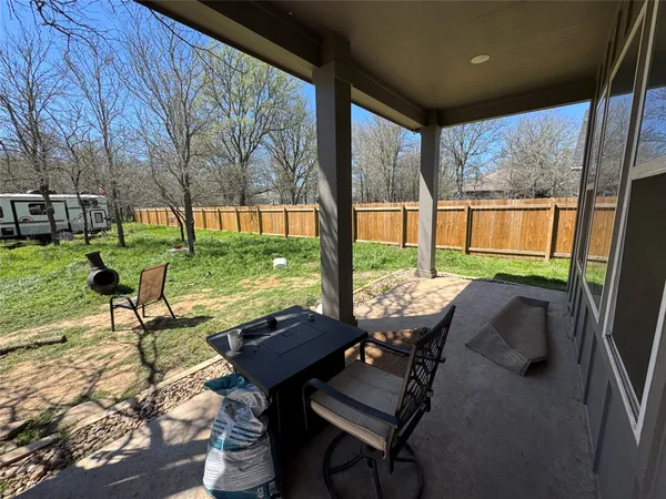 a view of a porch with chairs and backyard