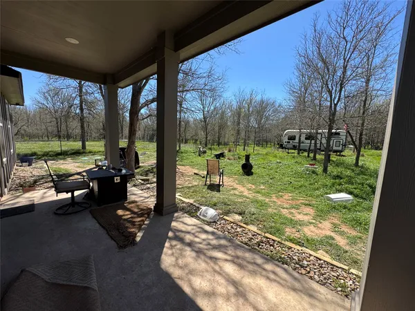 a view of a porch with furniture and yard