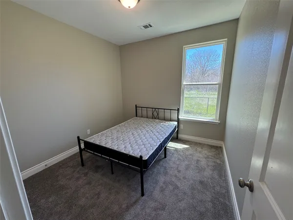 a room with pool table and a window
