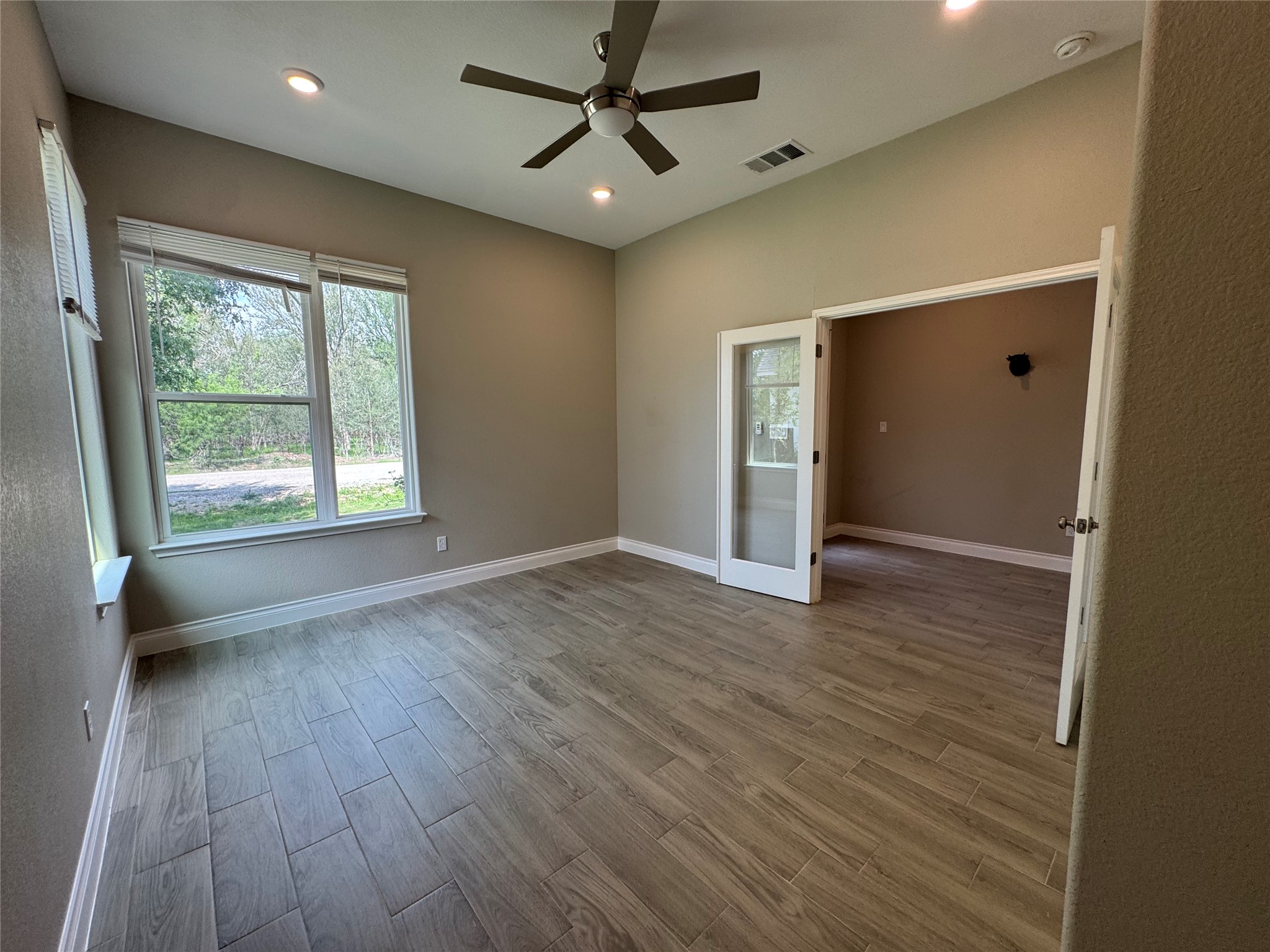 109 Mokulua Bastrop, TX 78602 - Photo 10 of 32 wooden floor in an empty room with a window