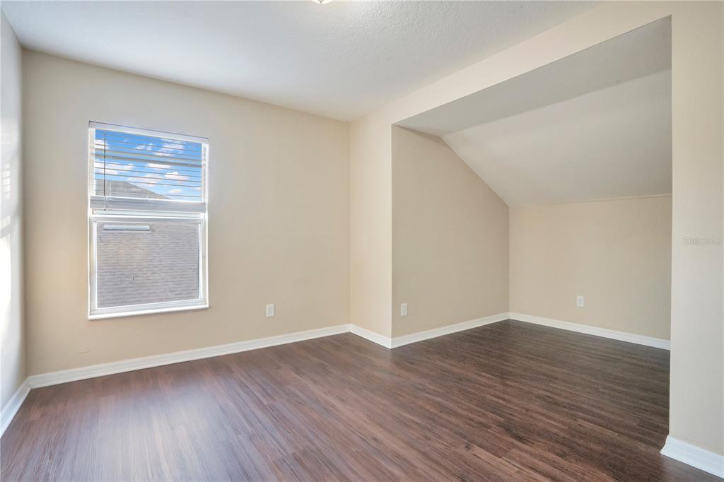 15031 Skip Jack Loop Lakewood Ranch, FL 34202 - Photo 23 of 27 a view of an empty room with wooden floor and a window