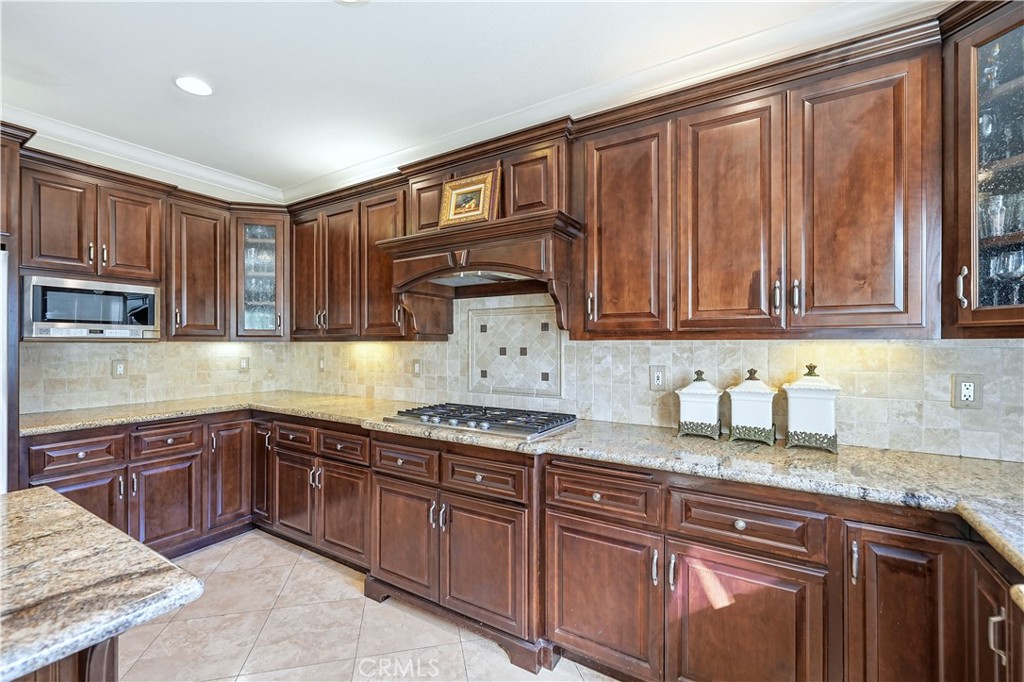 10 Boulder Ridge Court Azusa, CA 91702 - Photo 13 of 50 a kitchen with stainless steel appliances granite countertop a sink dishwasher stove and cabinets with wooden floor
