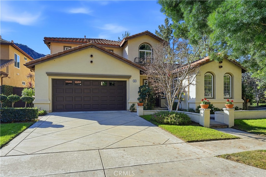 10 Boulder Ridge Court Azusa, CA 91702 - Photo 2 of 50 a front view of a house with a yard and garage