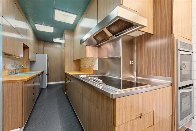 a kitchen with stainless steel appliances granite countertop a sink and cabinets