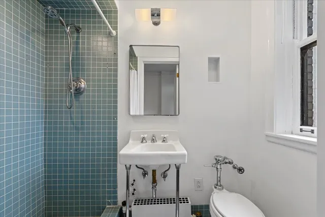 a bathroom with a sink a toilet and mirror