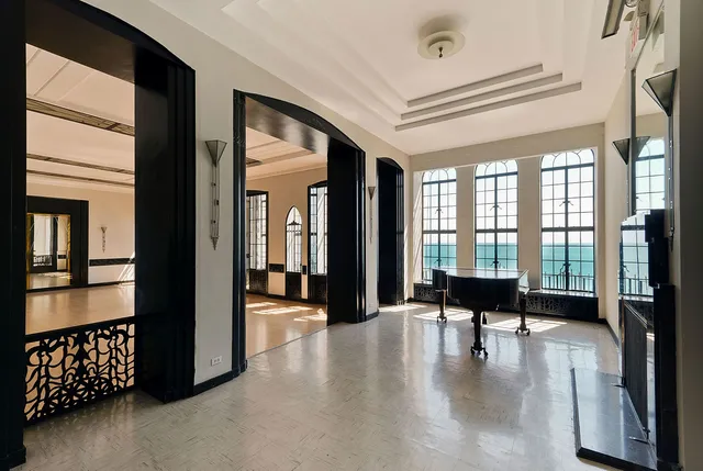 a lobby with furniture and floor to ceiling window