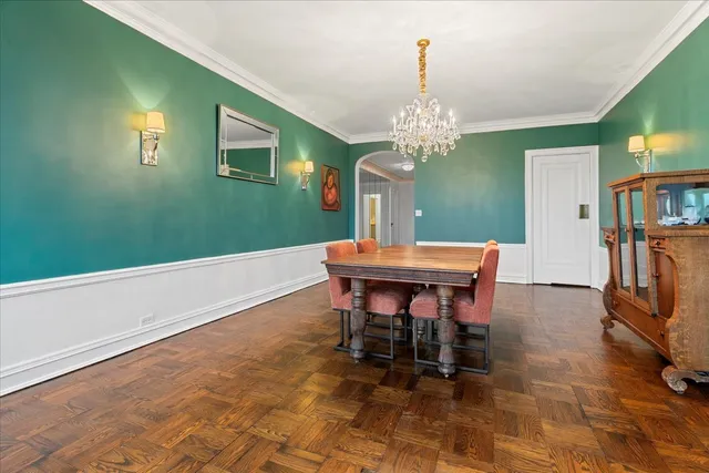 a view of a dining room with furniture and a chandelier