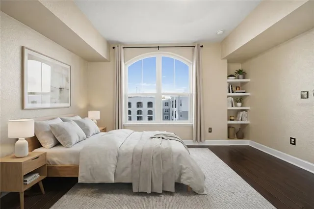 a bedroom with a large bed and a window