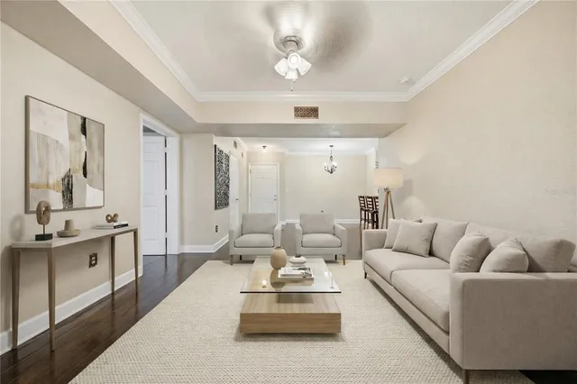 a living room with furniture and view of kitchen