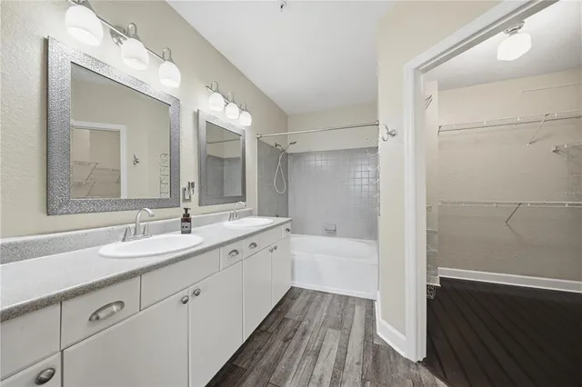 a bathroom with a tub sink and mirror