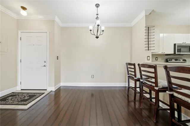 a view of a dining room with furniture and wooden floor