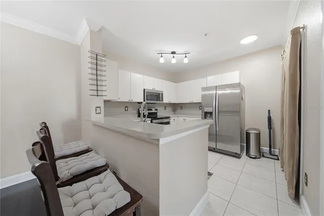 a kitchen with stainless steel appliances a refrigerator sink and cabinets