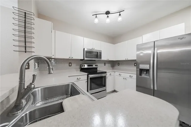 a kitchen with a refrigerator and a sink