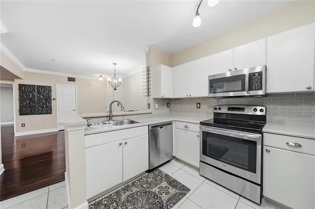 a kitchen with stainless steel appliances granite countertop a sink stove and microwave