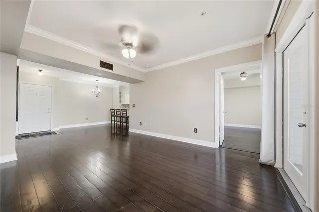 a view of empty room with wooden floor