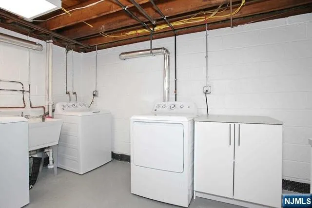 a utility room with a sink washer and dryer