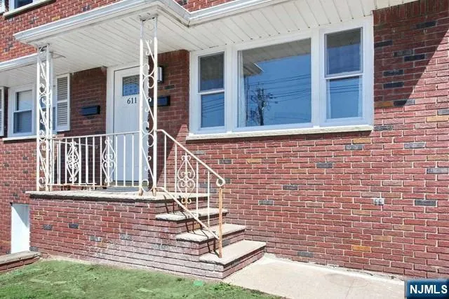 a view of a house with a small yard and wooden floor and fence