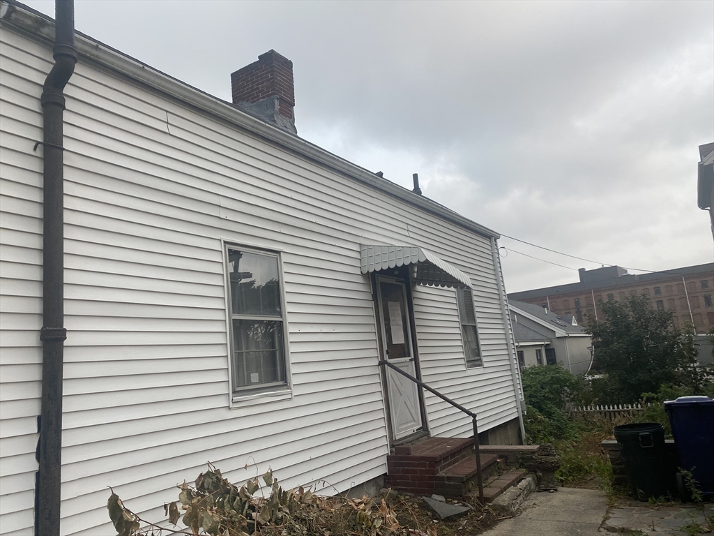 10 Dunmore Street Boston, MA 02119 - Photo 2 of 3 a view of a house with a yard and a garage