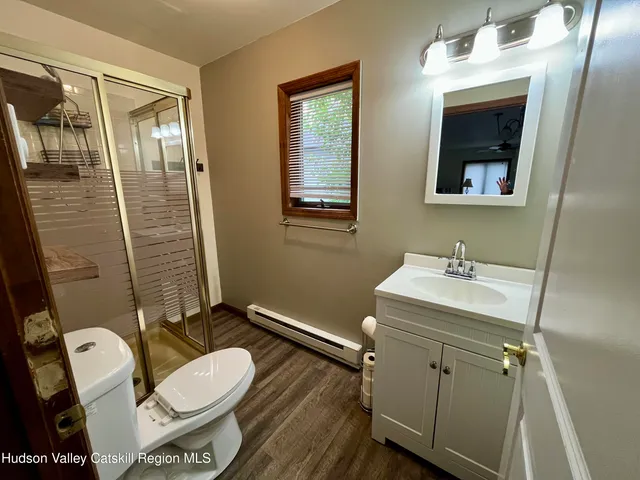 a bathroom with a sink mirror vanity and toilet