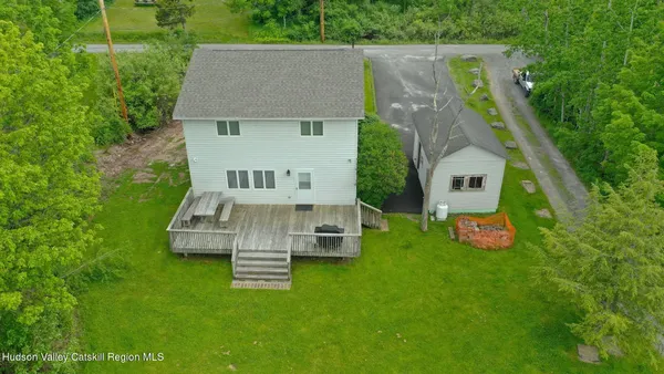 an aerial view of a house with backyard