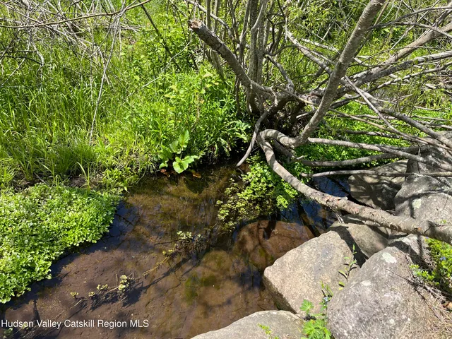a living room with hard wood floor and a flat screen tv
