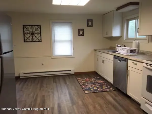 a kitchen with sink cabinets and wooden floor