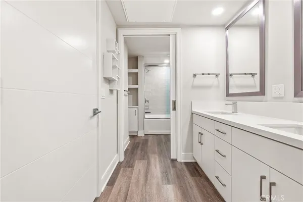 a view of a hallway with wooden floor