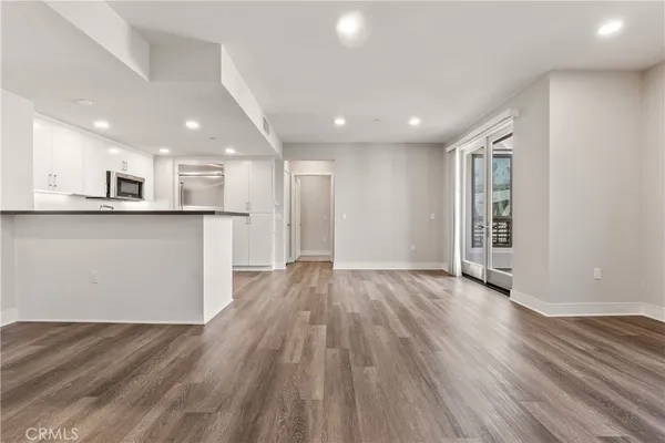 a kitchen with granite countertop white cabinets and stainless steel appliances