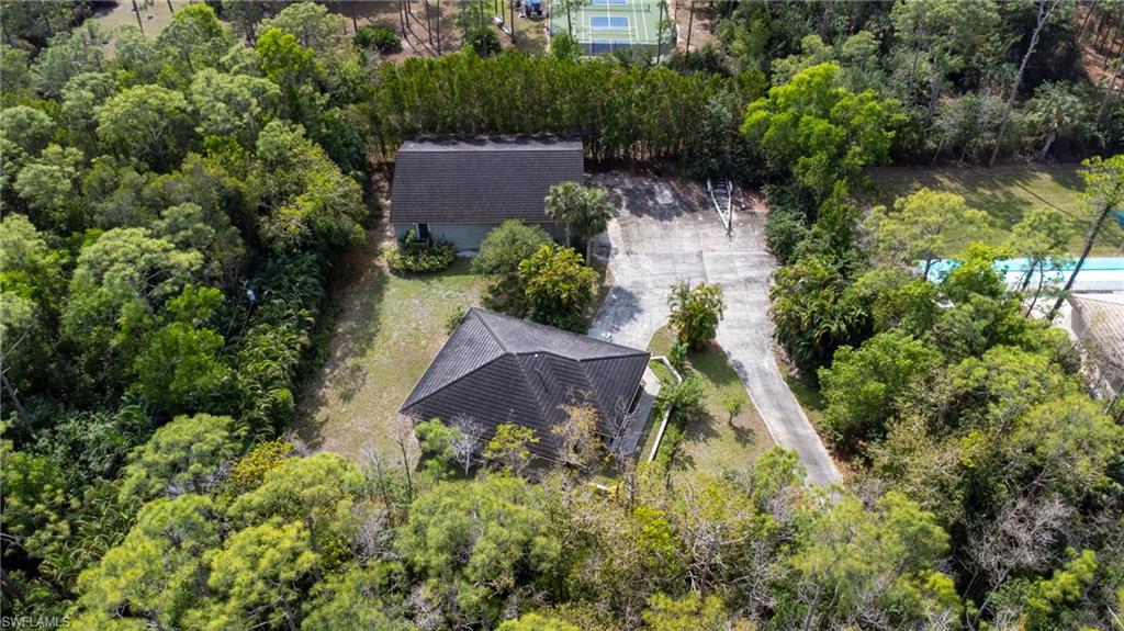 6800 Hunters Road Naples, FL 34109 - Photo 11 of 16 an aerial view of a house with a yard and large trees
