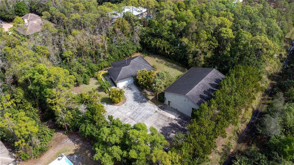 6800 Hunters Road Naples, FL 34109 - Photo 12 of 16 an aerial view of a house with a yard and outdoor seating