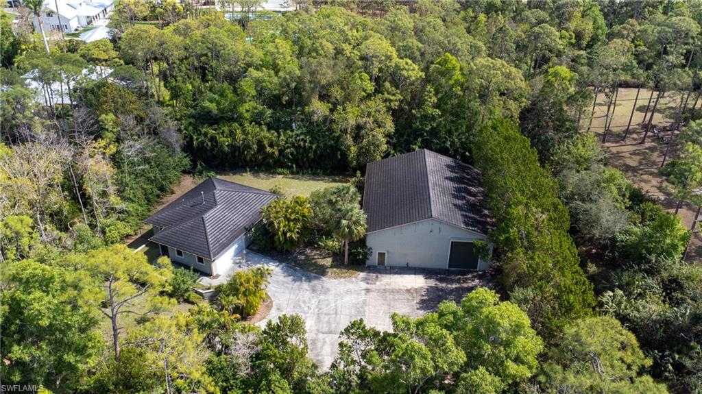 6800 Hunters Road Naples, FL 34109 - Photo 3 of 16 an aerial view of a house with a yard and trees all around