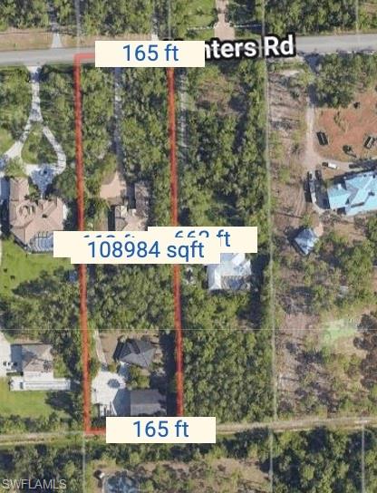 6800 Hunters Road Naples, FL 34109 - Photo 4 of 16 a sign that is sitting on a brick wall