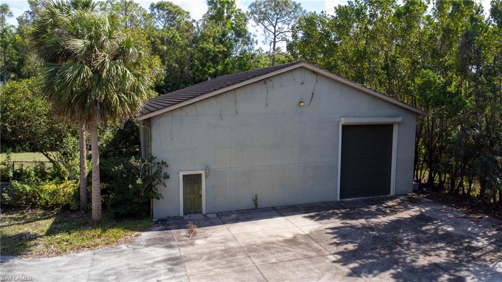 6800 Hunters Road Naples, FL 34109 - Photo 6 of 16 a house with a tree in front of it