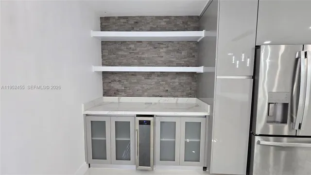 a kitchen with a refrigerator and countertop