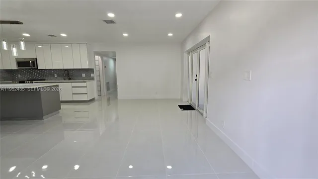 a view of a kitchen with white cabinets