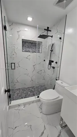 a bathroom with a sink toilet and shower