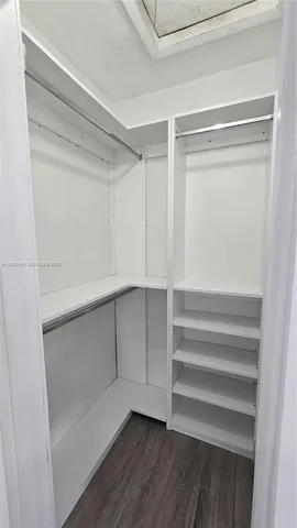 a view of walk in closet with empty racks
