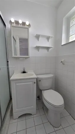 a view of a room with wooden floor and a window