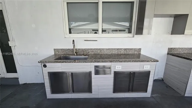 a kitchen with a stove top oven sink and window