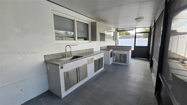 a dining room with furniture a chandelier and wooden floor