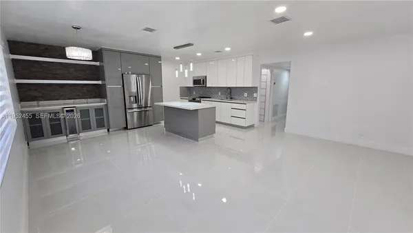 a kitchen with stainless steel appliances a refrigerator and a stove top oven